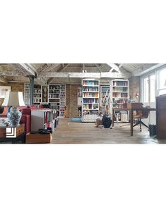 a room filled with lots of books and furniture