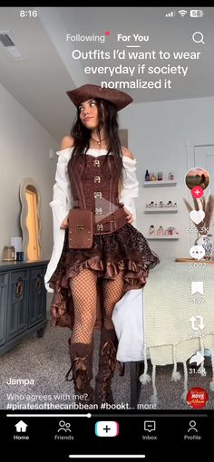 a woman in a pirate costume is standing next to a bed and looking at the camera