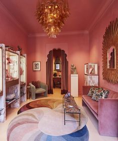 a living room filled with furniture and a chandelier