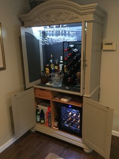 a cabinet that has some bottles in it