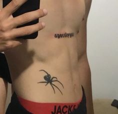 a man with a spider tattoo on his stomach