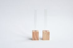 two glass vases sitting on top of each other in front of a white background