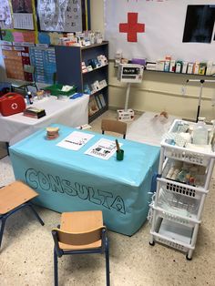 a blue table with writing on it in a room filled with medical supplies and desks