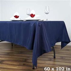 the table is set with two wine glasses on it