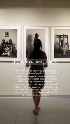 a woman standing in front of three black and white pictures on the wall with words written below