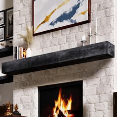 a living room with a fire place in the center and pictures on the wall above it