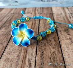 a blue and yellow flower on a wooden table