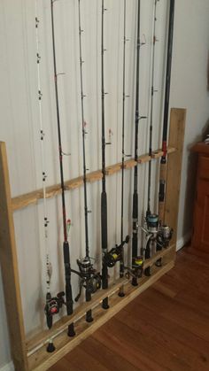 the fishing rods are lined up against the wall