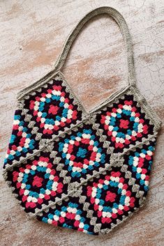 a crocheted purse sitting on top of a wooden table