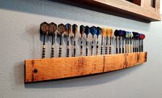 a wooden rack with many different types of golf clubs hanging on it's side