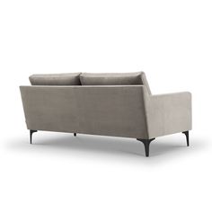 a gray couch sitting on top of a white floor