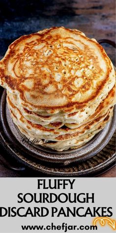 fluffy sourdough discard pancakes on a metal pan with text overlay reading fluffy sourdough discard pancakes