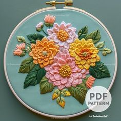 an embroidery pattern with flowers on the front and back of it, in pastel colors