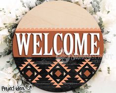 a wooden sign that says welcome with flowers in front of it and the words, project idea