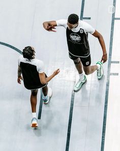 two men are playing basketball on the court