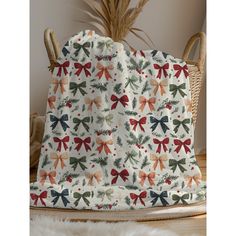 a blanket with bows on it sitting on top of a wooden table next to a basket