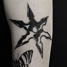 a black and white photo of a tattoo design on the left arm with an abstract star