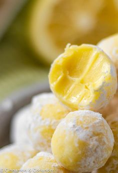 there is a bowl full of lemon pralies with powdered sugar on top