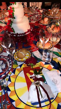 a table set with plates, silverware and wine glasses for an elegant wedding reception