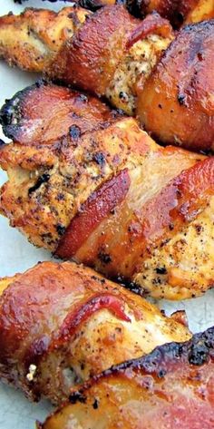 chicken wrapped in bacon on a white plate