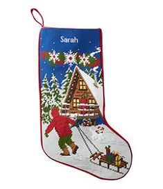 a cross stitch christmas stocking with santa and his sleigh in the snow