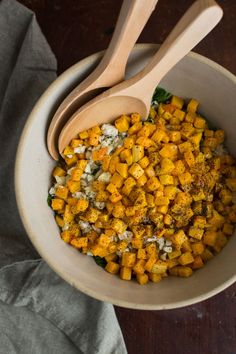 a wooden spoon in a bowl filled with food