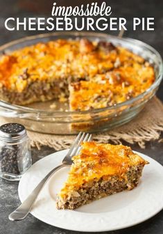 a piece of cheeseburger pie on a white plate with a fork next to it