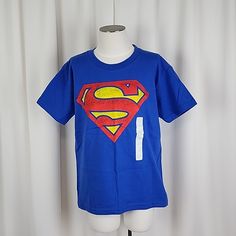 Superman Classic Logo T Shirt Royal Color: Royal Blue Size: S Fit: Classic Pit To Pit: 15.4“ Approx Sleeve Length: 5.4 “ Approx Length: 20.0“ Approx Material: 100% Cotton Care: Machine Wash Cold Description: Superman Logo Printed Across The Front, Crew Neck Style, Short Sleeve Condition: New, Tags Have Fallen Off But Will Be Included, Smells Very Flowery, Creases From Storage Kc81j5 Blue Short Sleeve Superhero Tops, Blue Superhero Crew Neck Top, Blue Superhero Short Sleeve Top, Superhero Short Sleeve T-shirt With Letter Print, Superman Boy, Blue Superhero T-shirt With Character Print, Long Tshirt Dress, Wonder Woman Shirt, Dc Comics Shirts