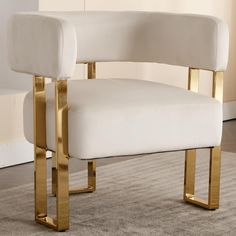 a white chair with gold legs in a room