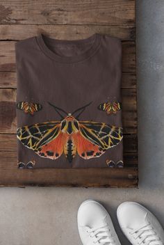 Thanks for stopping by! Cottagecore Moths Shirt Printed on a super soft, cotton tee Dispatched in 5 working days or sooner Unisex Free UK delivery Material: 100% ringspun cotton. Chest (to fit): S  34/36   M  38   L  40/42   XL  44/46   XXL  48/50 ECO-FRIENDLY Each garment is made to order, reducing extra material and energy that would be otherwise wasted We use DTG printing process which is easier on the environment than screen-printing Our ink is bright and also eco-friendly. Do not tumble dry Witchy Clothing, Alt Clothing, Grunge Clothing, Butterfly Shirt, T Shirt Company, Butterfly Shirts, Black Balloons, Vibe Clothes, Dtg Printing