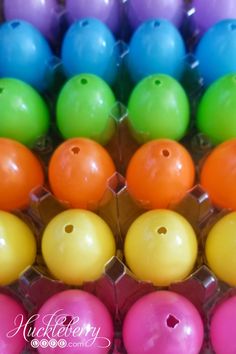 many different colored bowling balls in an egg carton