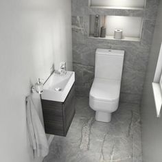 a white toilet sitting next to a sink under a window in a bathroom with gray marble flooring