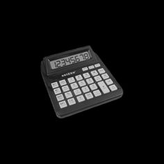 a black and white calculator on a black background