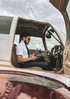 a man sitting in the cockpit of an airplane