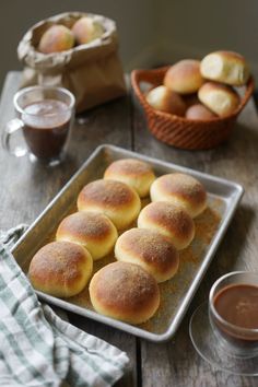 bread rolls on a baking sheet with dipping sauce