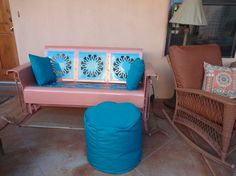 a pink and blue bench sitting on top of a tile floor next to a chair