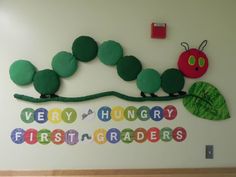 the very hungry first grader's wall is decorated with paper and felt caterpillars