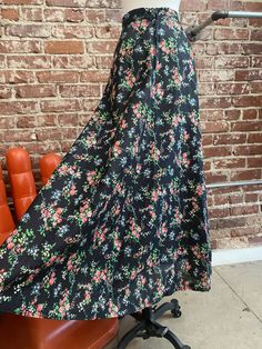 "70s Black Floral High Waisted Long A Line Cotton Skirt. Exquisite seventies cotton black floral high waist skirt. The cotton fabric is incredible, so heavenly with a stunning black floral print. The a line cut is so flattering. In perfect condition. I love this skirt. 27\" waist 42\" hip 41\" length Feel free to message me with any questions. I'm happy to help and quick to respond. 🍎 Stay in touch @look.vintage" Vintage Floral Print Tiered Skirt, Black Floral Print Maxi Skirt For Spring, Retro Black Skirt For Spring, Summer Black Maxi Skirt With Floral Print, Bohemian Black Skirt With Floral Print, Vintage Tiered Skirt With Floral Print, Retro Spring Flowy Maxi Skirt, Retro Flared Maxi Skirt For Spring, Retro Flowy Maxi Skirt For Spring