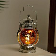 a glass tea light holder with a star wars scene on the front and side, sitting on a table