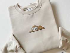 Embroidered Sloth Sweatshirt, Embroidered Sloth Shirt, Sleeping Sloth Shirt, Funny Sloth Shirt, Coffee Sloth Hoodie, Lazy Sloth Lover Gift This Cute Embroidered Sloth Sweatshirt is a must-have for your all season wardrobe! Whether you're running errands, going for a walk, attending a concert/party, or staying cozy at home, this unisex sweatshirt is perfect for you! Our crewnecks are made from the highest quality fabric for an incredibly soft and comfortable fit, with advanced printing to ensure that the colors and graphics are vibrant and detailed. ❤ The price is for ONE item only. If you want to order matching shirts, add each item separately by choosing different colors and sizes each time, and add each one into your cart. ❤ This unisex sweater is intended to be oversized and loose-fitti Concert Party, Cozy At Home, Sloth Shirt, Funny Sloth, Sloths Funny, Sloth Lovers, Matching Sweaters, Animal Sweatshirt, Easy Trendy Outfits