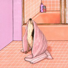 a dog wrapped in a pink towel sitting on the floor next to a bath tub