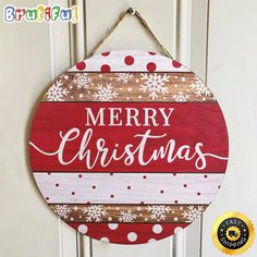 a merry christmas sign hanging on a door with snowflakes and polka dotes