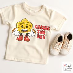 "Capture the joy and laughter of your little one with our adorable \"Cheese the Day\" toddler shirt! This playful tee combines a delightful pun with your toddler's infectious smile, making it a perfect addition to their wardrobe. Whether they're posing for photos or enjoying their favorite activities, this shirt will have everyone smiling along. Our unique and eye-catching shirts are crafted using the latest DTG (Direct-to-Garment) technology, ensuring high-quality prints that capture every detail of our designs. While we take immense care to maintain color accuracy in our products, it's important to remember that colors may appear slightly different on your computer monitor due to variations in display settings. The brightness, contrast, and color calibration of each screen can influence Playful Funny Print T-shirt For First Birthday, Funny First Birthday T-shirt, Funny Toddler Shirt, Toddler Humor, Toddler Snacks, Birthday Gifts For Boys, Kids Birthday Cards, Retro Tshirt, Kids Prints