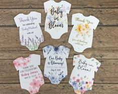 six baby onesuits with flowers and thank you for coming home written on them