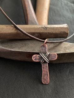 "Show your faith with this humble, rustic cross. I hammer and forge each of these crosses by hand from pure, organic copper and wrap it with 925 Sterling silver. Each cross is finished with a rustic patina which gives it an antiqued look. These are perfect for men or women. Dark brown cowhide leather cording is 24\" in length and is adjustable. Necklace slips over the head. If you would like another style chain like a ball chain or cable chain please message me before ordering. Prices may vary b Artisan Adjustable Cross Jewelry, Rustic Cross Jewelry For Gifts, Rustic Cross Jewelry Gift, Rustic Brown Hammered Jewelry, Artisan Brown Cross Jewelry, Adjustable Brown Cross Necklace, Deer Horn Jewelry, Copper Jewelry Diy, Bow Rack