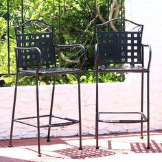 two metal chairs sitting next to each other