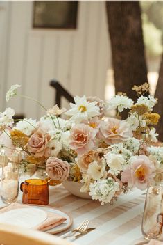 a table topped with vases filled with flowers