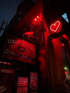 a red neon sign on the side of a building that says love's today