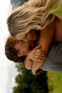 a young man and woman kissing each other