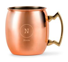 a copper colored coffee mug with the letter n on it's side and handles